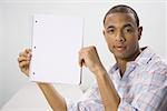 African American male student holding blank workbook