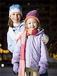 Two girls outdoors in winter smiling