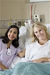 Portrait of a female doctor consoling a female patient