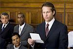 Juror standing in a jury box and reading the verdict