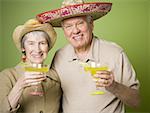 Portrait of an elderly couple holding glasses of lemon juice