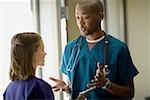 Close-up of a male doctor talking to a female doctor