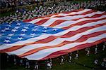 High angle view of a group of people holding a large American Flag