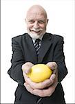 Portrait of a businessman holding a lemon