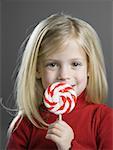 Portrait of a girl holding a lollipop