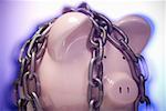 Close-up of a chained piggy bank