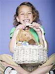 Portrait of a girl holding Easter eggs in a wicker basket