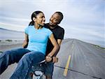 Young couple sitting on a bicycle