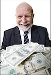 Close-up of a businessman with American dollar bills in front of him