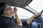 Close-up of a mid adult woman talking on a cell phone and holding an eyeliner