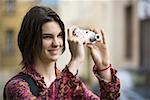 Teenage girl taking a photograph
