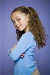 Close-up of a girl standing with her arms crossed