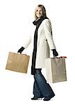 Portrait of a young woman carrying shopping bags