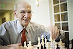 Elderly man playing chess