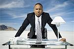 Portrait of a businessman leaning over a table