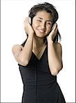 Young woman listening to music on headphones