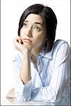 Close-up of a young woman thinking with her hand on her chin