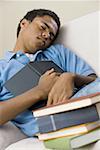 Teenage boy sleeping with a book on his chest