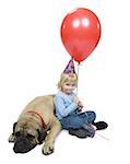 Portrait of a girl sitting beside a dog holding a balloon