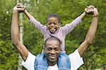 Portrait of a father carrying his son on his shoulders