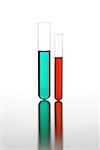 Close-up of two test tubes with colored liquid