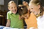 Close-up of three girls sitting together