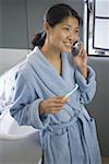 High angle view of a mid adult woman talking on a mobile phone in the bathroom