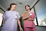 Close-up of two female nurses walking in a corridor