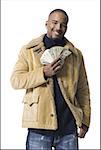 African American holding a pile of dollar bills