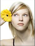 Nahaufnahme einer jungen Frau eine Blume hinter ihr ins Ohr setzen