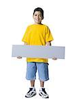 Portrait of a boy holding a blank sign