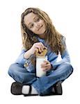 Portrait of a girl dipping a cookie into a glass of milk