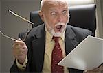 Close-up of a businessman holding a file and eyeglasses