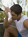 Profile of a mid adult man holding a water bottle