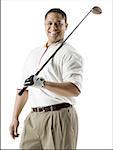 Portrait of a mid adult man holding a golf club