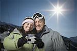 Low angle view of an adult couple looking at a digital camera