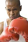 Close-up of a young man wearing boxing gloves