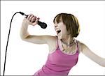 Close-up of a teenage girl singing into a microphone
