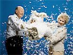 Older couple pillow fighting