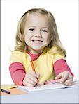 Portrait of a girl coloring with crayons