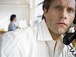 Portrait of a mid adult man talking on the telephone