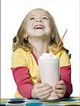 Close-up of a girl holding a milkshake
