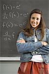 Female student leaning against chalkboard