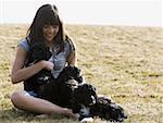 Girl with puppies outdoors smiling