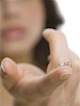 Close-up of contact lens on the tip of a woman's finger