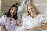 Portrait of a female doctor and a female patient smiling