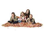 Family sitting in autumn leaves