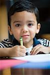 Portrait of a boy coloring