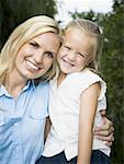 Portrait of a young woman and her daughter smiling