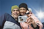 Low angle view of an adult woman and a young man taking a photograph of themselves